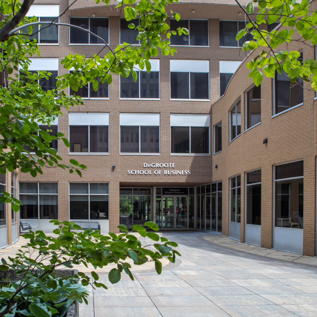 The DeGroote School of Business, a multi-story, brick building.