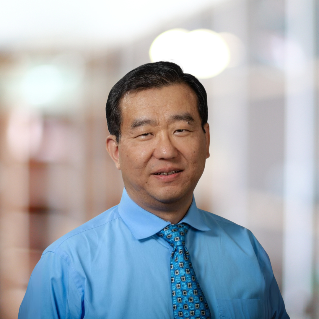 Headshot of Alfred Liu, a smiling man with short, dark hair, in a blue collared shirt.