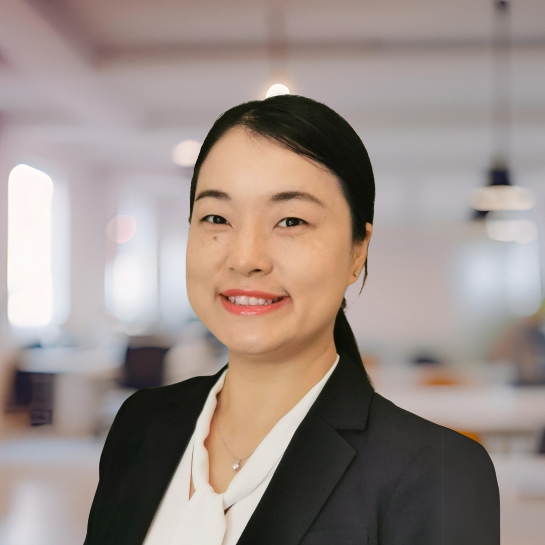 Headshot of Lingling Shi, a smiling woman with a dark ponytail, wearing a black blazer.