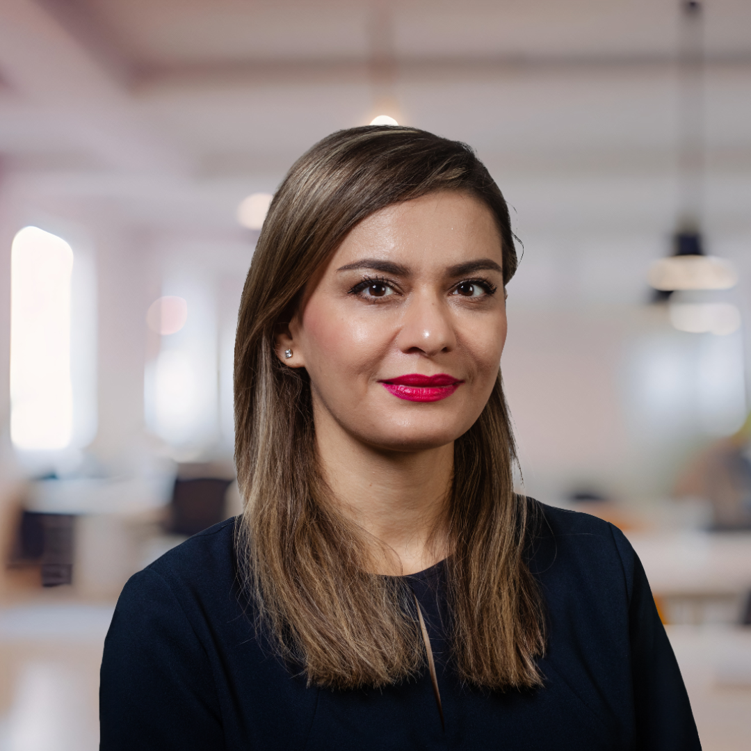 Headshot of Maryam Ghasemaghaei, a smiling woman with long, brown hair, wearing a black top.