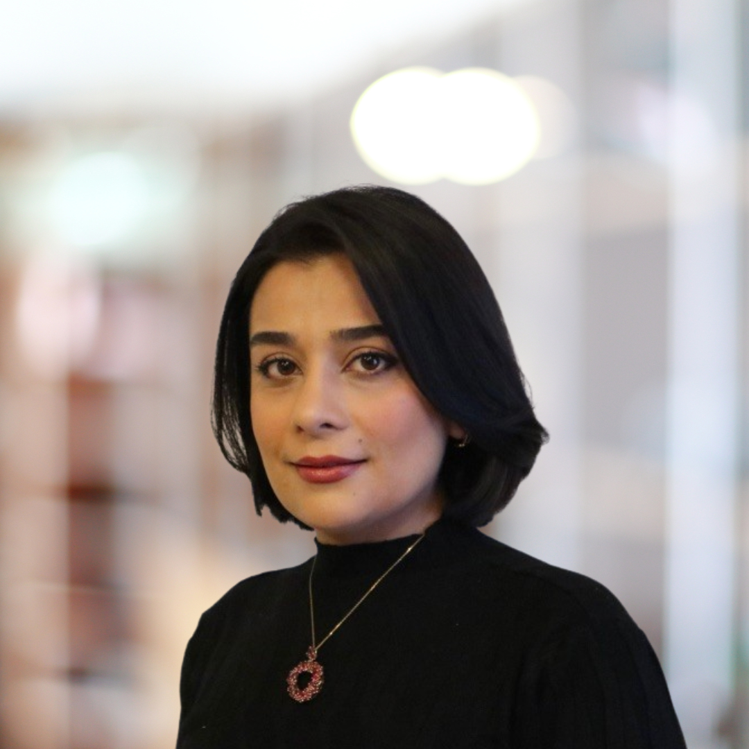 Headshot of Nooshin Salari, a smiling woman with short, dark hair, wearing a black top.