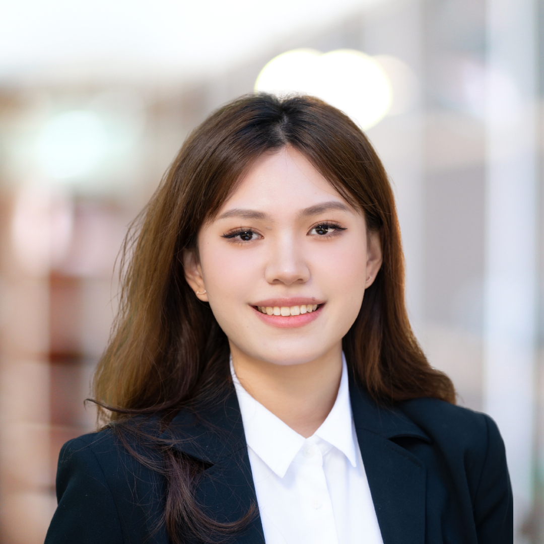 Headshot of Chenrui Zhang, a smiling woman with long, brown hair, wearing a navy blazer.