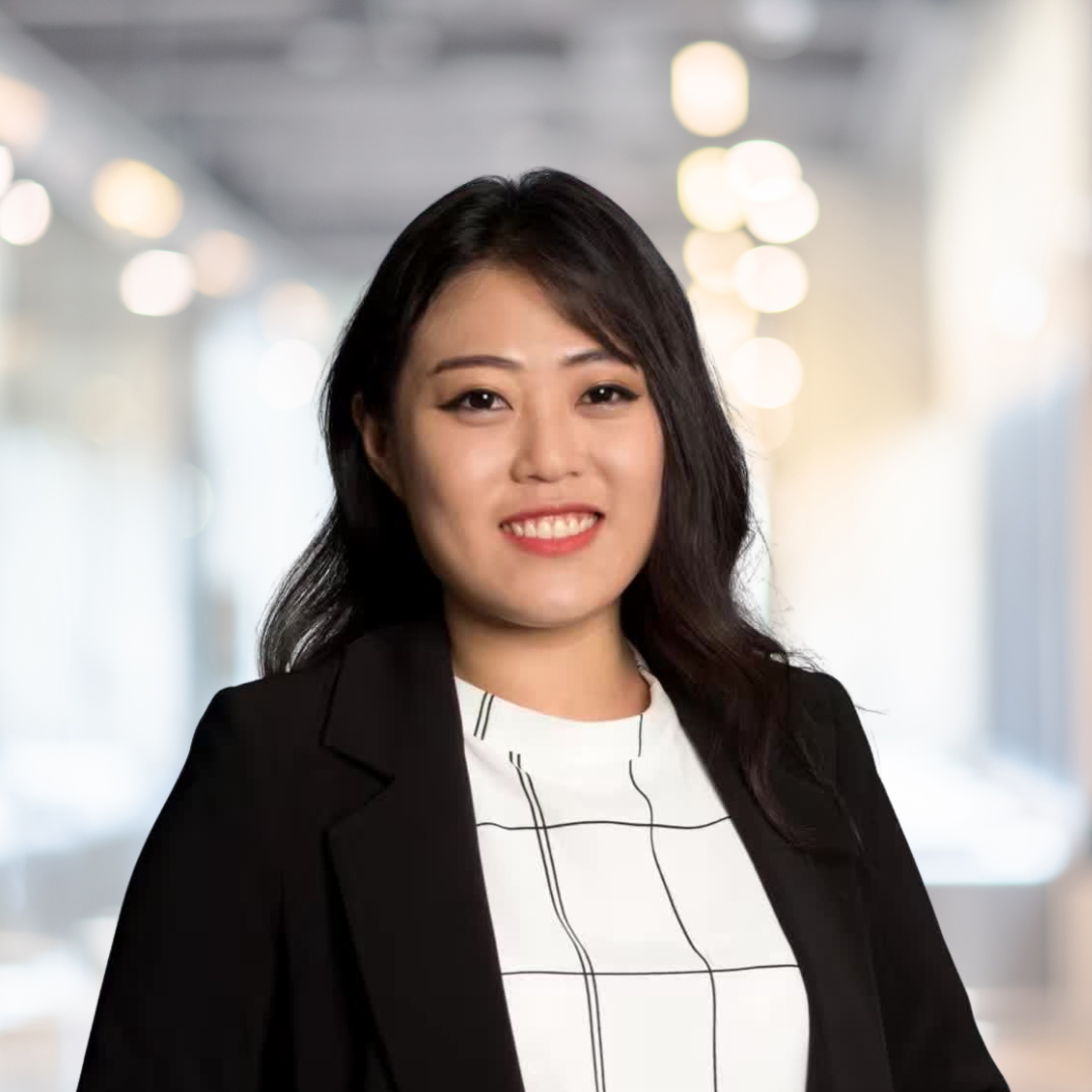 Headshot of Qiaochu Cai, a smiling woman with long, dark hair, wearing black blazer.