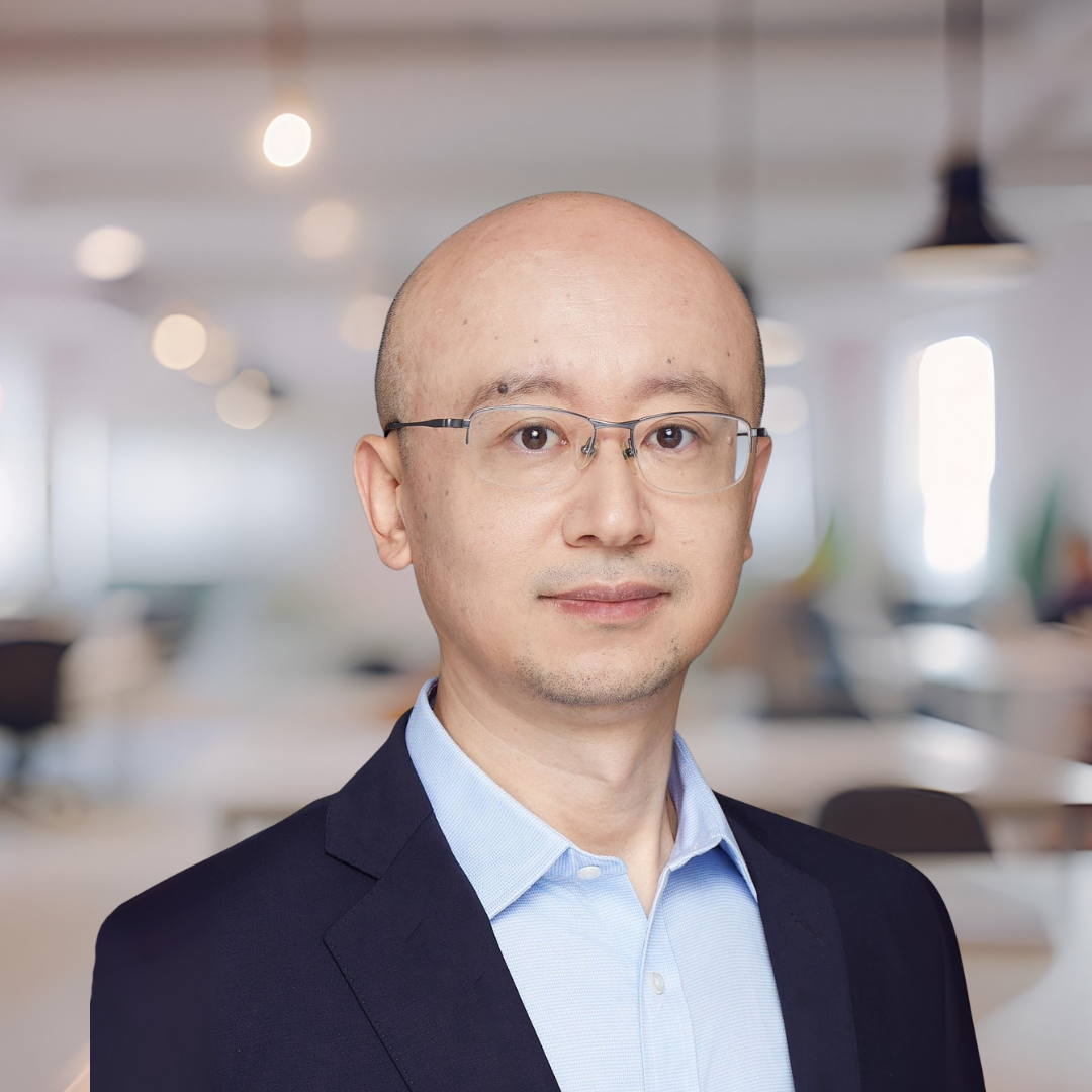 Headshot of Yingjie (Nick) Jiang, a bald man with glasses, wearing a dark blazer.
