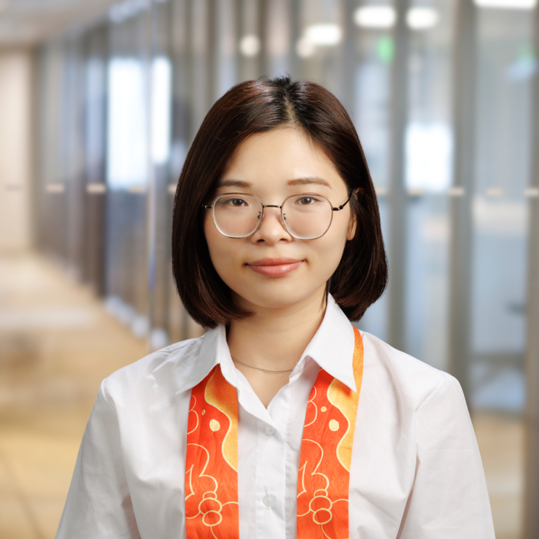 Headshot of Kylie Nguyen, a smiling woman with dark hair and glasses, wearing a white collared shirt.